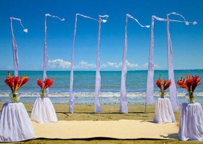 Elegant flags fluttering on a beach in Algarve, creating a stunning backdrop for a beach wedding celebration.