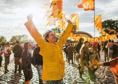 Colorful festival flags fluttering at an outdoor event, adding vibrancy and energy to the atmosphere.