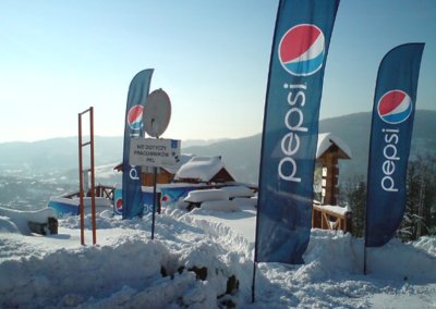 Pepsi brand flags at Mountain Sky Resort for the pop-up event, showcasing sponsor branding for the winter season.