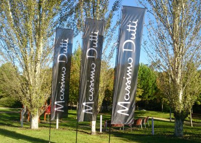 Custom flags for a corporate outdoor event, featuring the Massimo Dutti brand logo, perfect for marketing brand activations. Adding sophistication and branding visibility.