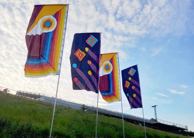 Festival flags in the UK displayed at an outdoor event, showcasing vibrant colors and festive designs.