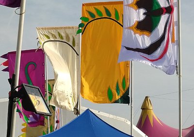 Magical Garden Festival in Amsterdam with vibrant festival flags adding color to illuminated garden pathways.